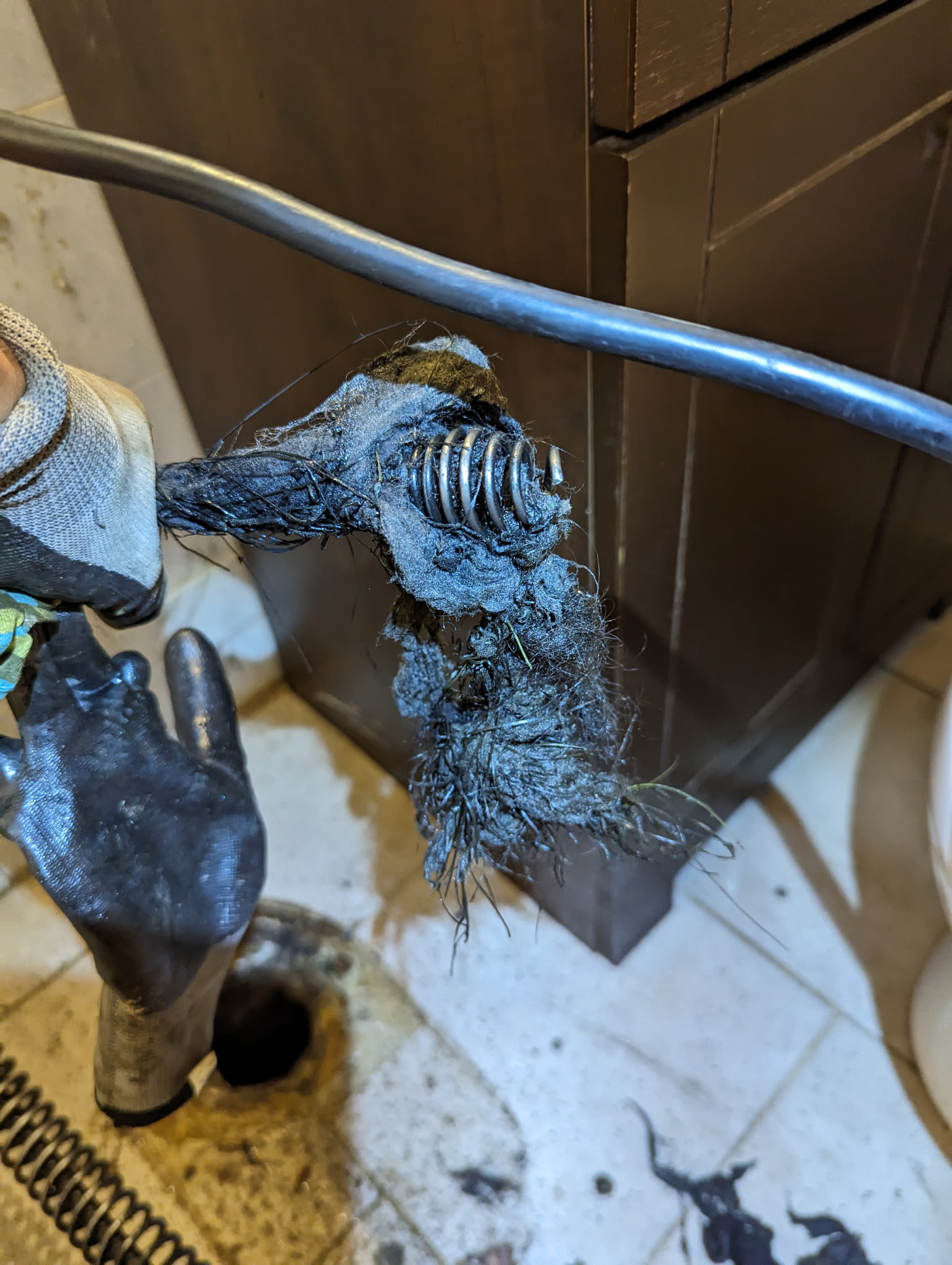 High-pressure water jetting clearing drain blockage